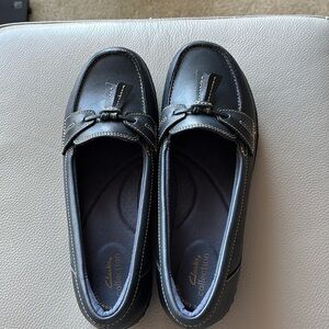 Clark’s new black loafers.